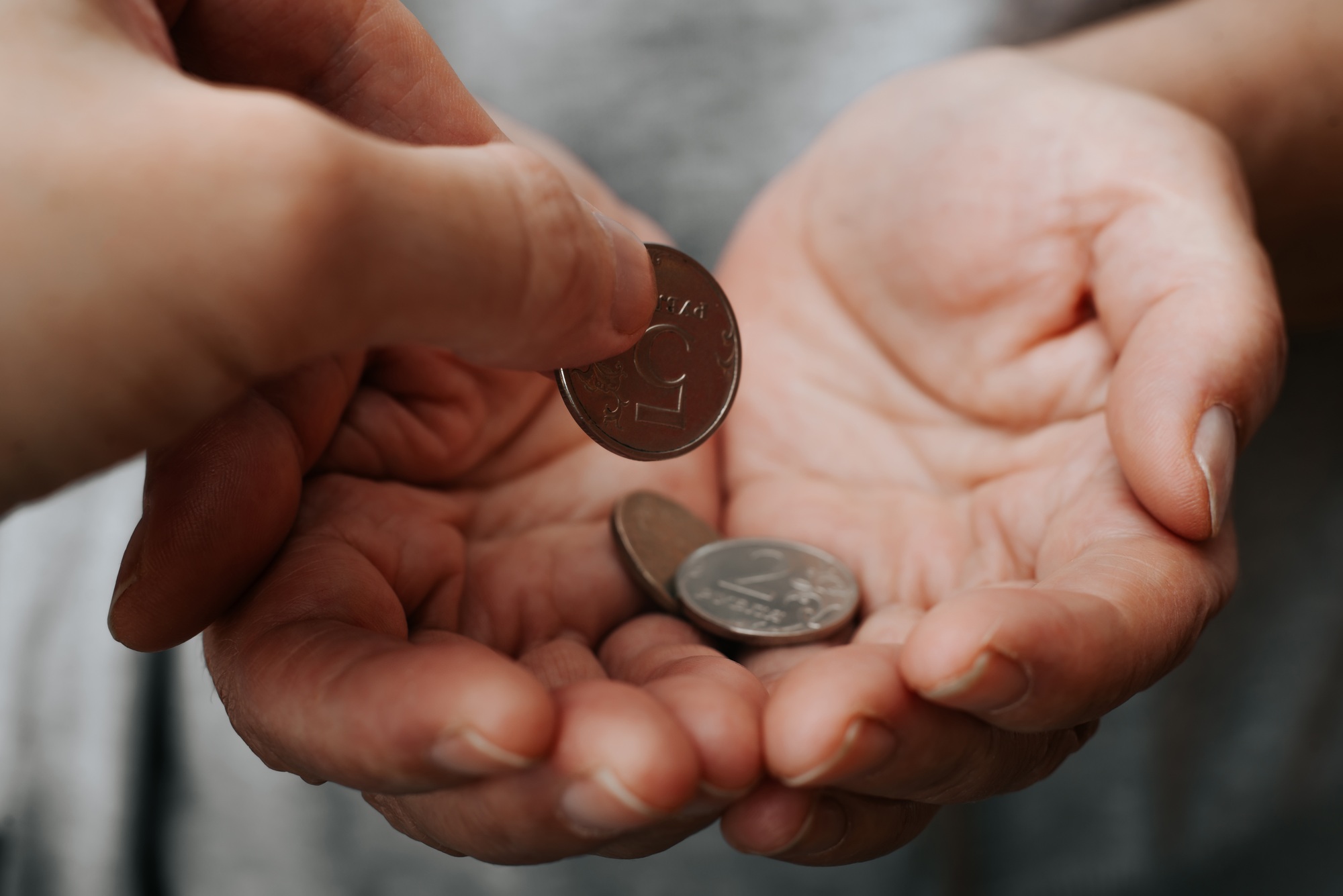 Poverty, financial social problems, poor, charity, help concept. Hand giving money in palms,